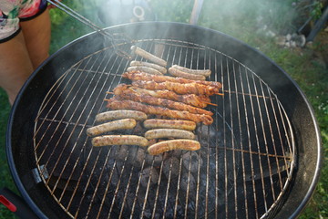 Sausages barbecue with a charcoal barbecue in the garden
