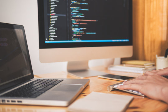 Close up hand of developing programming and coding technologies. Programmer hand typing on keyboard. Put on the wood table. Programmer concepts.