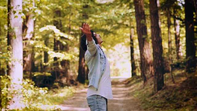 Young Man Enjoying The Nature, Outstretched Arms While Enjoying The Fresh Air In Green Forest