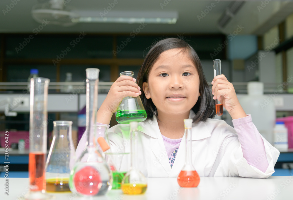 Wall mural little scienctist making experiment in laboratory,