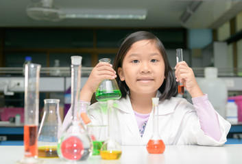 little scienctist making experiment in laboratory,