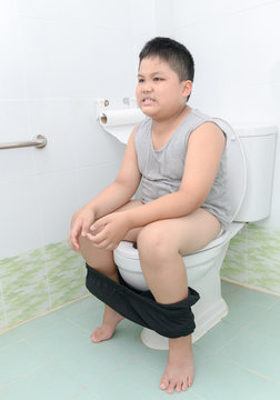 12 jear old boy nude fat boy suffer stomach and sit in toilet Stock Photo | Adobe Stock