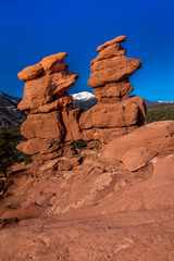 Fototapeta na wymiar MARCH 8, 2017 - SIAMESE TWINS RED ROCKS AT GARDEN OF THE GODS SHOW PIKES PEAK VIEW, COLOARDO SPRINGS, CO, USA - a National Natural Landmark showing Sedimentary red rock formations
