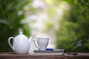 White kettle and cup with notebooks