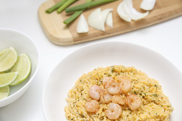 Detail of a special risotto with shrimp, raw onions and lime
