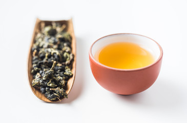 Asia culture and design concept - fresh taiwan oolong tea dry bud and chinese porcelain teacup