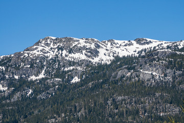beautiful mountain range covered by snow in early spring under the blue sky