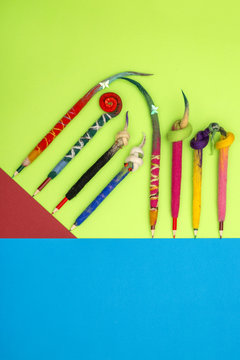 Pencils in a cover of fulled wool on a colour background