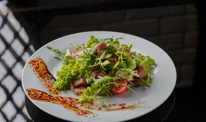 Vegetable salad on a plate on a glass background