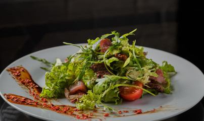 Vegetable salad on a plate on a glass background