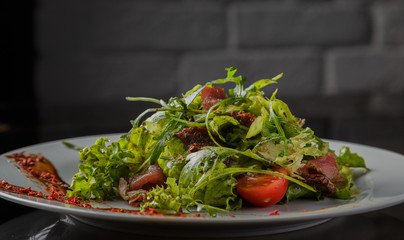 Vegetable salad on a plate on a glass background