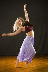 Young woman dancing in the studio on a hardwood floor.