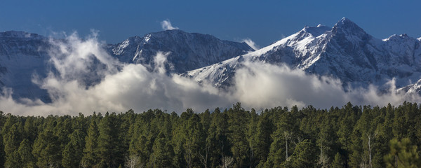 View of  San Juan Mountains with clouds below peaks outside Ridgway, Colorado