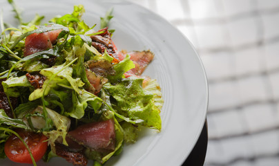 Vegetable salad on a plate on a glass background