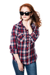 Young woman wearing sunglasses in plaid shirt.