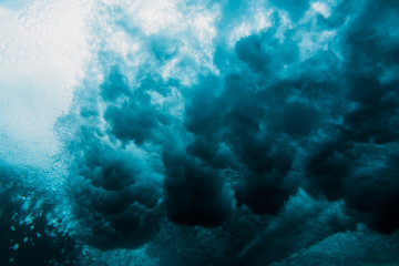 Naklejka na ściany i meble Ocean wave underwater. Blue ocean in underwater