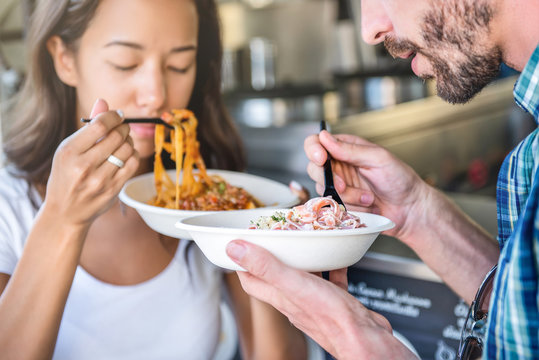 Couple Eating Pasta From Food Truck With Pleasure