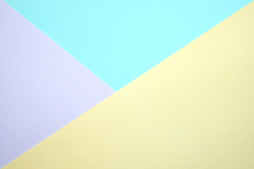 Fashionable  pastel colored paper flat lay top view, geometric background texture, pink, purple, yellow, beige, green and blue.
