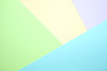 Fashionable  pastel colored paper flat lay top view, geometric background texture, pink, purple, yellow, beige, green and blue.