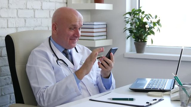 Enthusiastic Doctor in Office Room Read Cellphone Good News Gesturing Happy