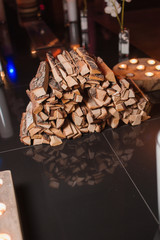 Firewood on a glass surface with a dark background