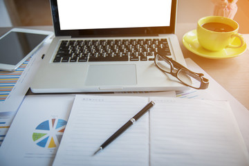 Laptop with blank screen on table.