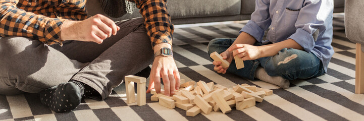 Man and kid arranging bricks © Photographee.eu
