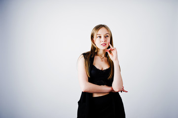 Girl model in black wear posed at studio on white background.