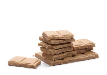 White nougat chocolate bar pieces with hazelnuts isolated on white background