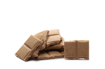 White nougat chocolate bar pieces with hazelnuts isolated on white background