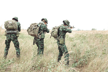 Fototapeta premium Soldier ready his weapon. Standing up holding their assault rifle. Portrait full body shot. Digital green camo.