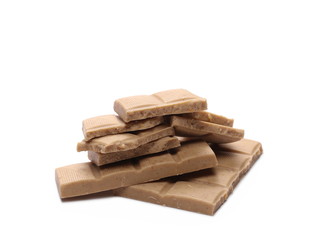 White nougat chocolate bar pieces with hazelnuts isolated on white background