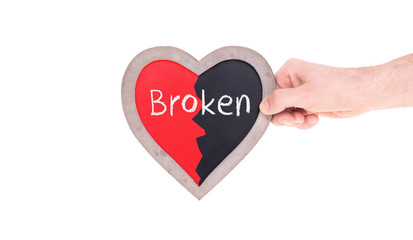 Adult holding heart shaped chalkboard - Broken