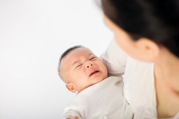 Mother trying to comfort her crying baby isolated