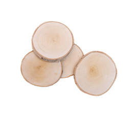 Sawn birch wooden logs on round discs isolated on white background.