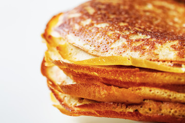A stack of golden pancakes. Closeup, selective focus