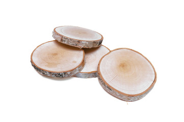 Sawn birch wooden logs on round discs isolated on white background.