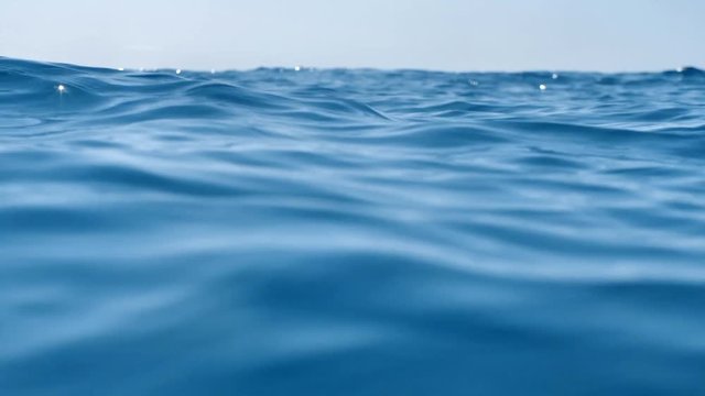 Waves in blue pure sea. Camera swing in ocean. Concept of ecology.