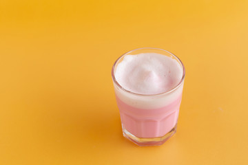 Strawberry milk shake from the glass on pink background