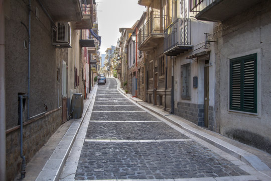 Fototapeta Narrow street of Lascari in Sicily, Italy