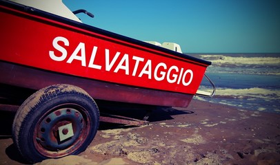 boat with text that means Rescue in Italian language with old vintage effect