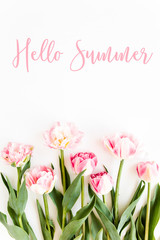 Hello summer text, pink tulips on white background. Minimal floral concept greeting card. Flat lay, top view.