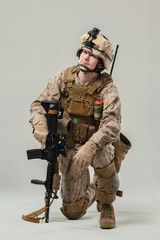 Soldier in camouflage holding rifle