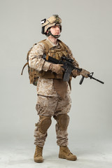 Soldier in camouflage holding rifle