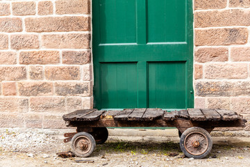 Lower view of disused trolly, with broken planks of wood, in Cromford mill, Derbyshire, England.