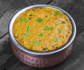 Indian Vegetarian Cuisine Dal Makhani Also Know as Dal Makhni or Daal Makhani is A Popular Dish From Punjab, Cooked With Black Lentil, Red Kidney Beans, Butter And Cream. on Vintage Wooden Background
