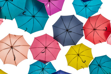 Bottom view of many umbrella of many colors on white background.