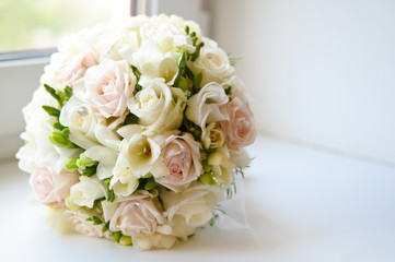 Beautiful round wedding bouquet of white and pink roses.