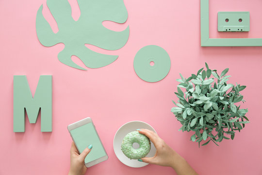 Girl holding phone and donut