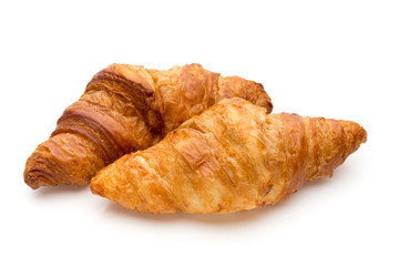 Tasty buttery croissants on the white background.